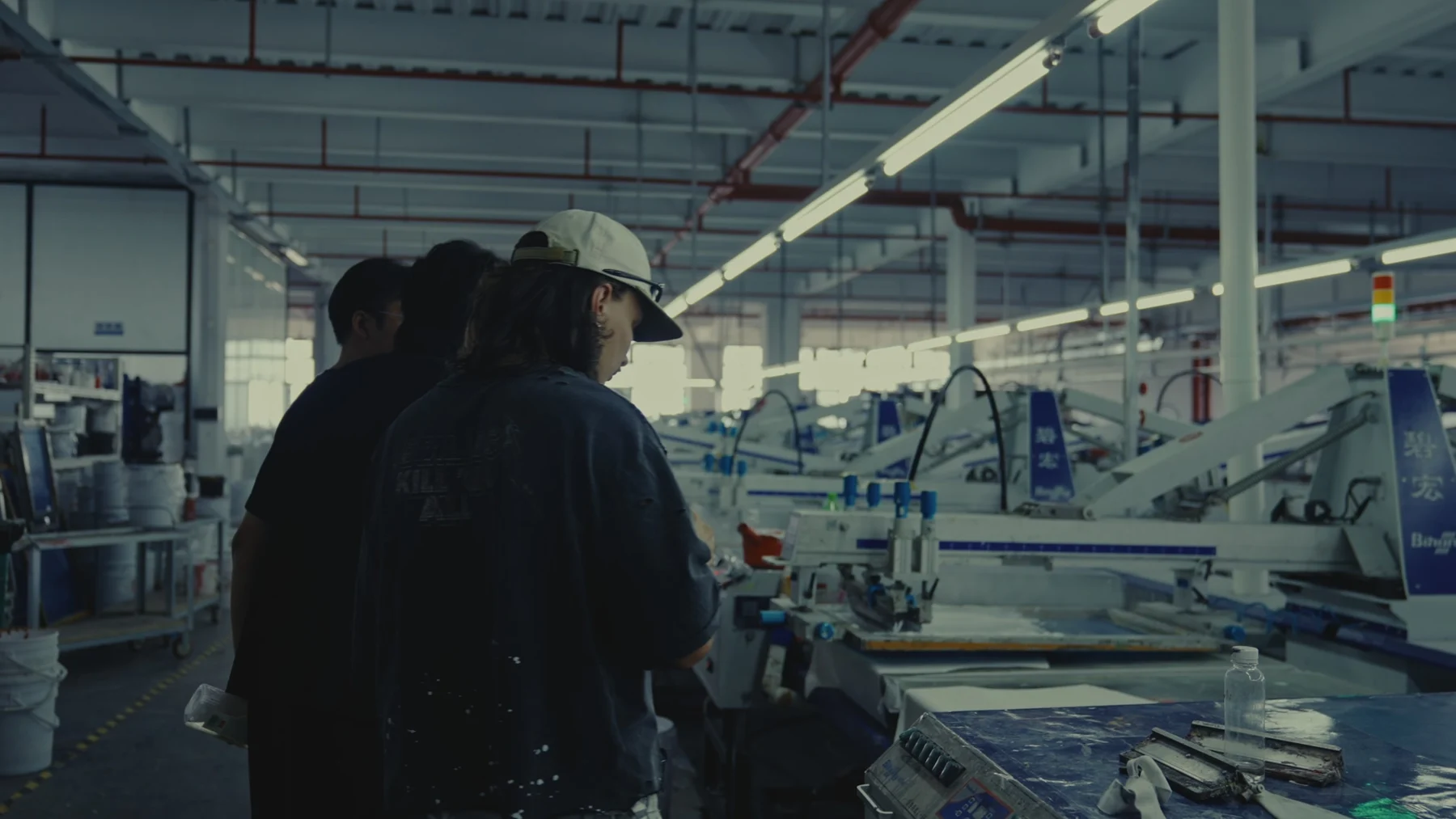 Alrightmade founders reviewing production machinery during a factory visit