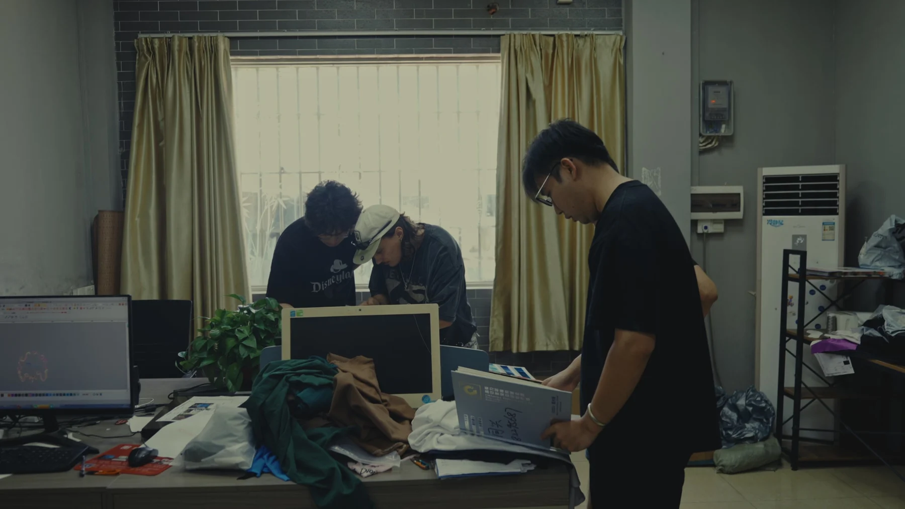 Alrightmade founders comparing fabric and development samples at a worktable