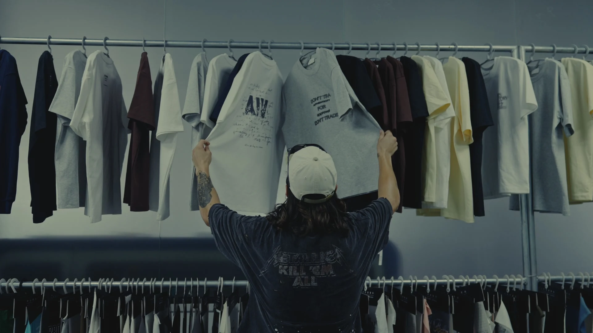 Apparel designer selecting and reviewing a finished garment