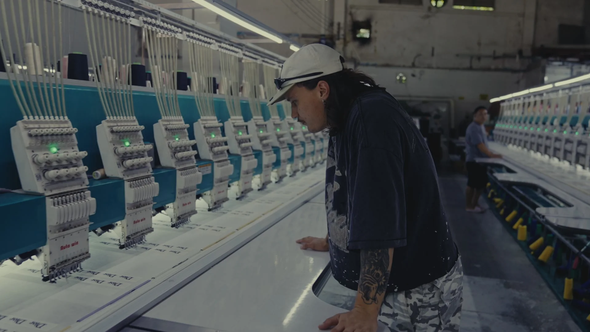 Operator monitoring a multi-head embroidery production line