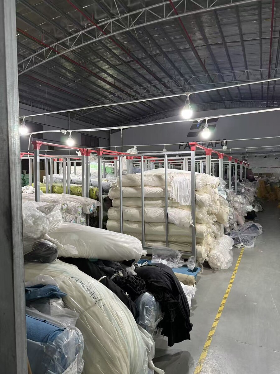 Fabric rolls and production materials stored in the garment factory warehouse