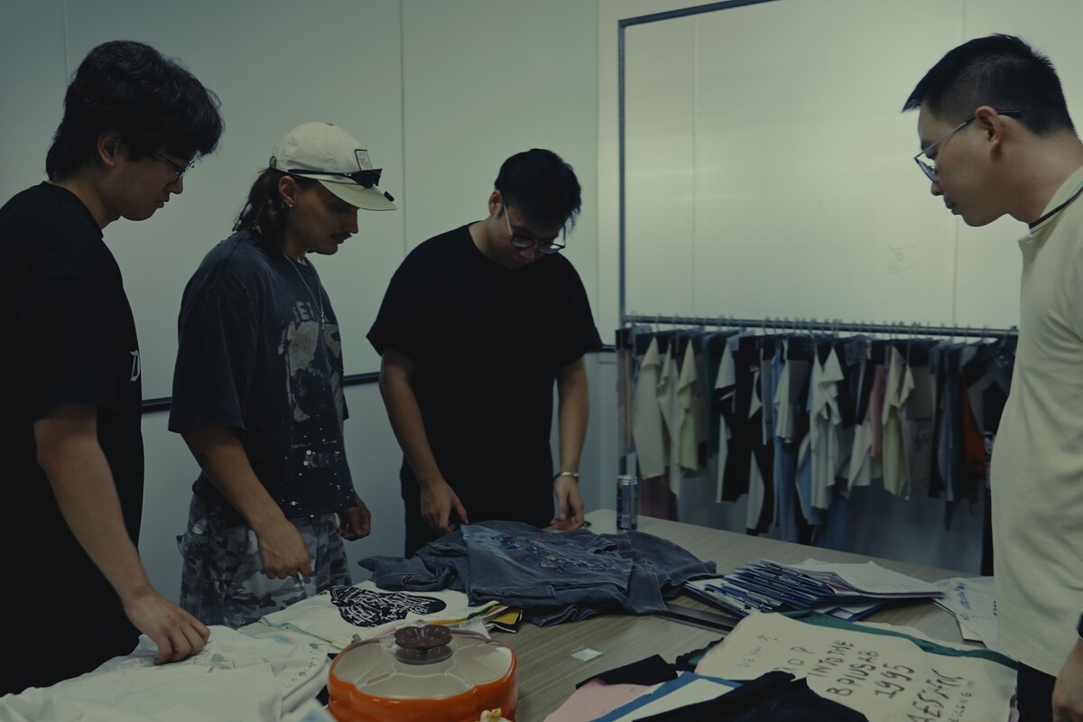 Developed garment and material references reviewed together in the sample room