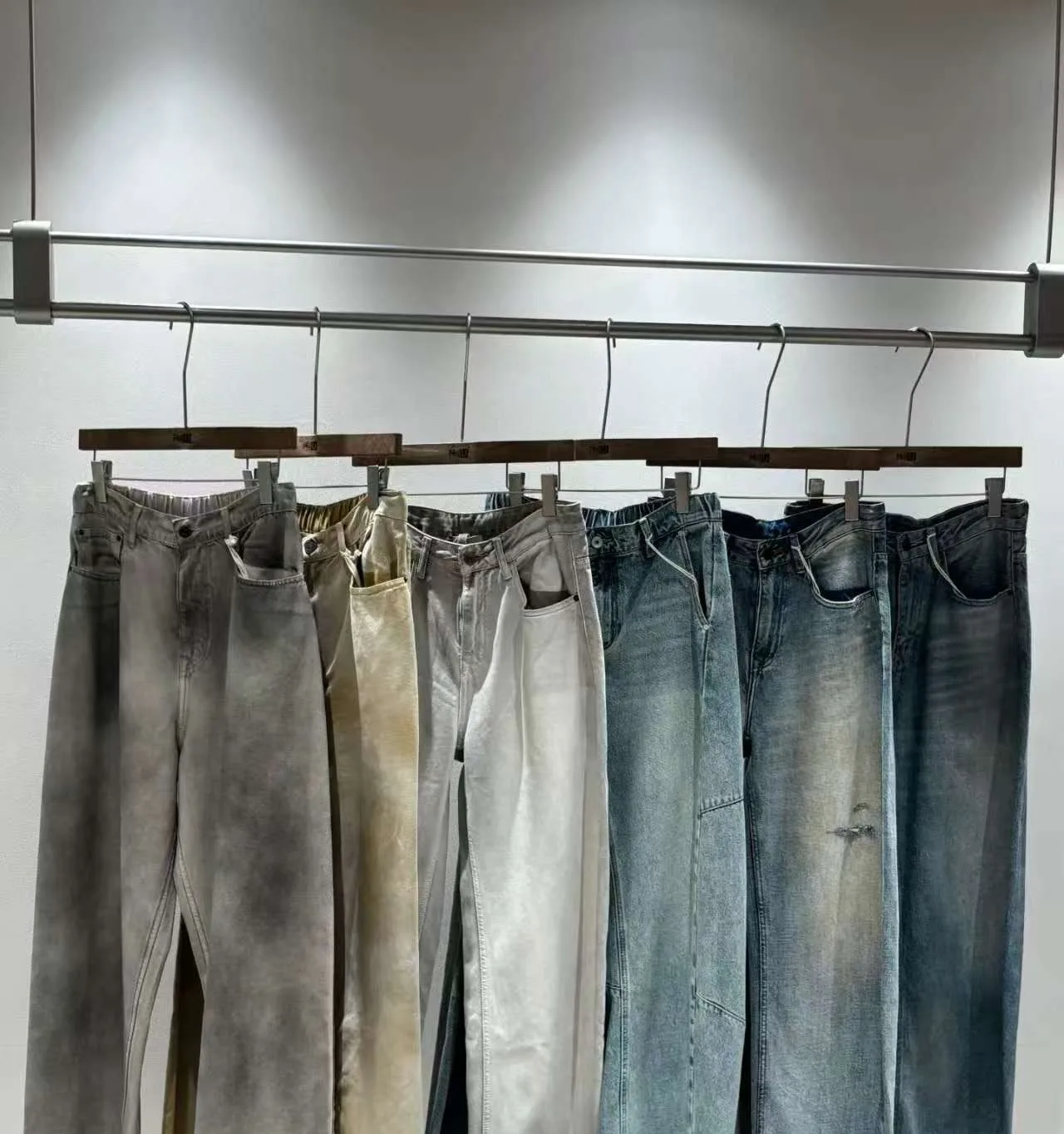 Wholesale denim trousers in multiple washes ready for inspection