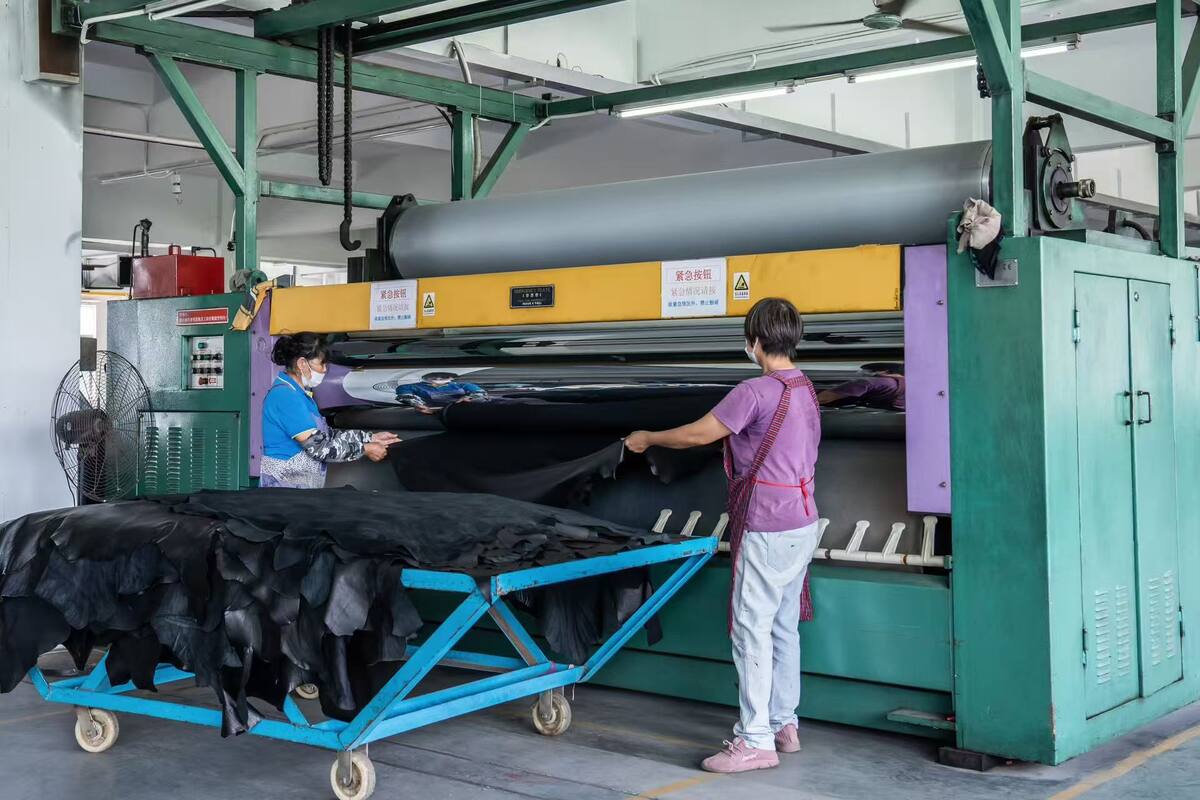 Leather ironing and flattening equipment in operation