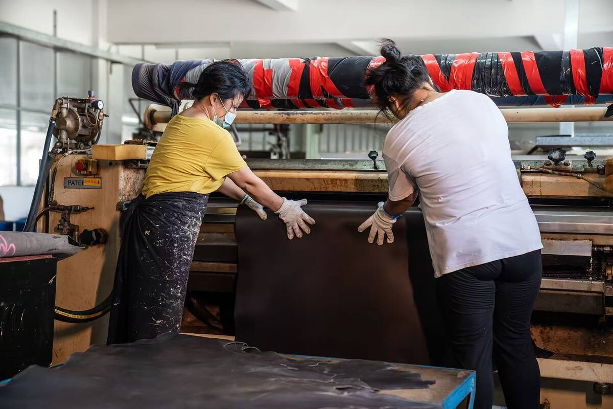 Team preparing finished leather for packing