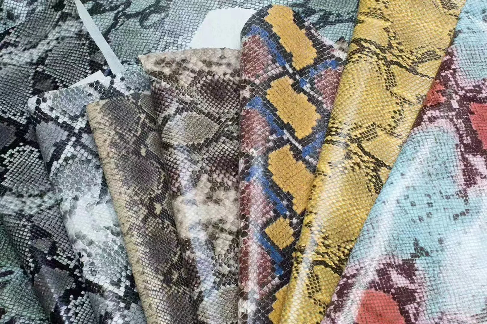 Colourful printed leather rolls with embossed snake-effect texture