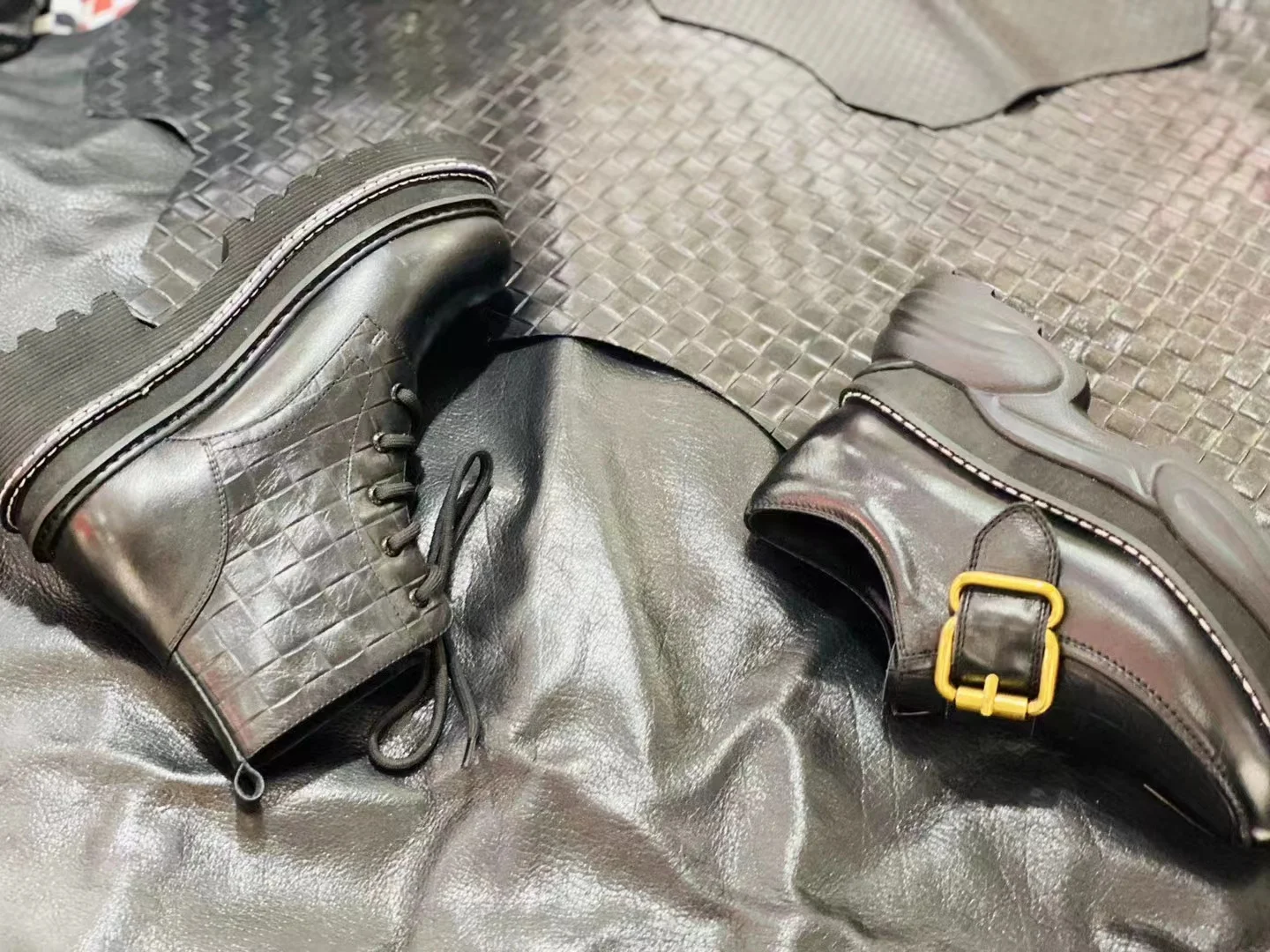 Footwear samples displayed on metallic-finish leather